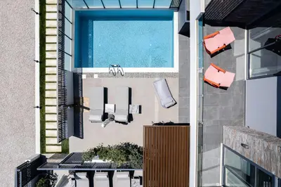 an external view of a balcony with a swimming pool at VillAgioi - Luxury villas, Private Pools, 450m to the Beach in Chania Town
