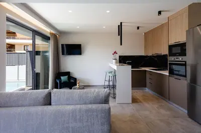 a living room with a couch and a kitchen at VillAgioi - Luxury villas, Private Pools, 450m to the Beach in Chania Town