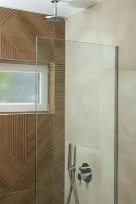 a shower with a glass door and a sink at Stefanie Studios in Agia Marina Nea Kydonias