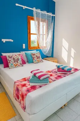 a bed with pillows on it in a room at Garden House in Khóra Sfakíon