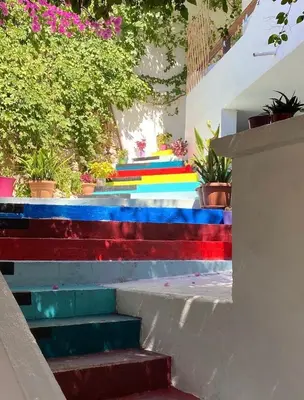 a group of colorful stairs with plants and flowers at Garden House in Khóra Sfakíon