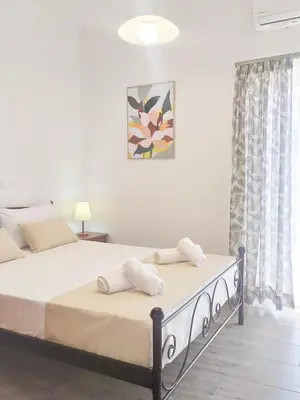 a bedroom with a bed with towels on it at Sea Side View Home steps from the beach & city in Chania Town