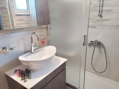 a bathroom with a sink and a shower at Sea Side View Home steps from the beach & city in Chania Town