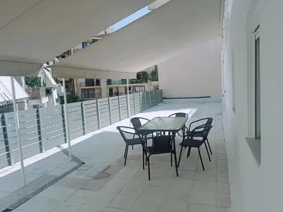 a patio with a table and chairs on a building at Oksana House in Chania Town