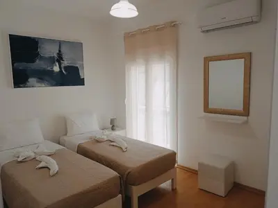 a bedroom with two beds with towels on them at Oksana House in Chania Town