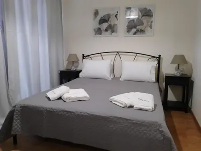 a bedroom with a bed with two towels on it at Domus Nicola in Chania Town
