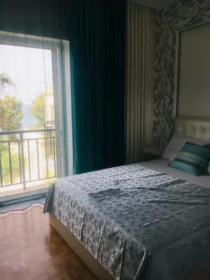 a bedroom with a bed and a large window at At the Beach! +10min= port&center. in Chania Town