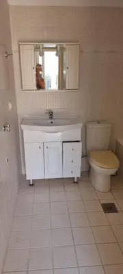 a bathroom with a sink and a toilet at Fifi's luxury apartment in Plataniás