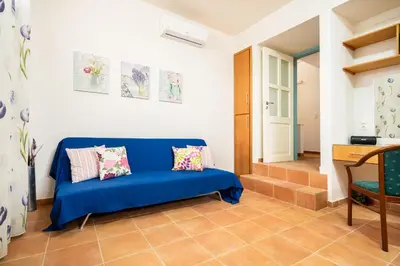 a blue couch in a room with a door at Beachfront villa Aqua Marine with private pool,ping-pong & BBQ in Chania Town