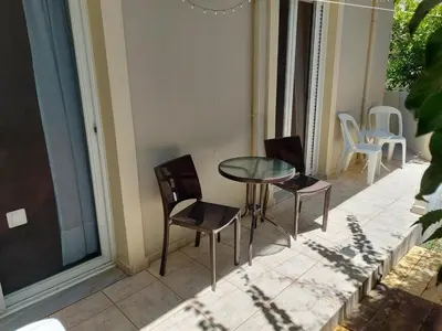 a patio with a table and chairs on a balcony at Chrissoula House In Agioi Apostoloi in Daratso