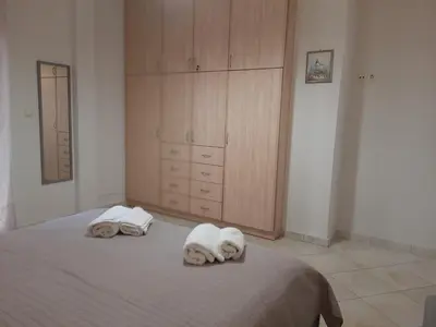 a bedroom with a bed with towels on it at Pavlos Apartment in Chania Town