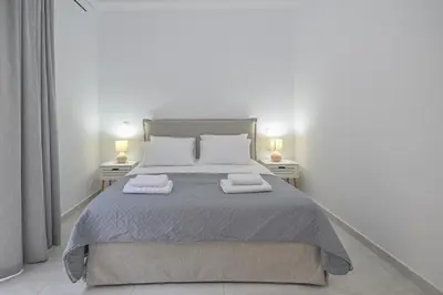 a bedroom with a bed with two towels on it at Moka Apartments in Chania Town