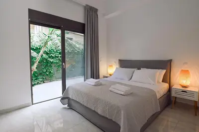 a bedroom with a bed and a large window at Moka Apartments in Chania Town