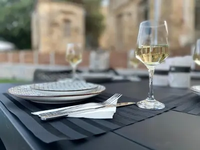 a glass of white wine sitting on a table at Casa Christina-Luxury Villa in Kissamos