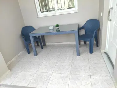 a blue table and two blue chairs in a room at NickTheGreekApartment in Galatás