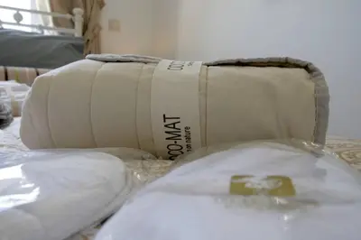 a bag sitting on top of a bed with pillows at Premium, 2-bedroom Apartment! in Chania Town