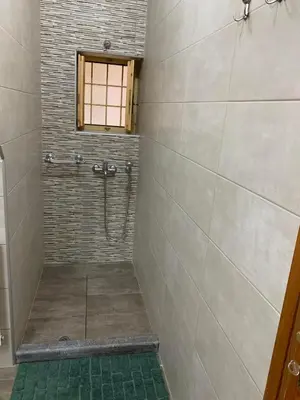 a bathroom with a shower with a window at VILLA FATIMA in Vryses