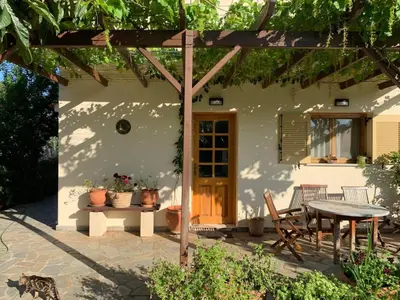 a patio in front of a house with a table at VILLA FATIMA in Vryses