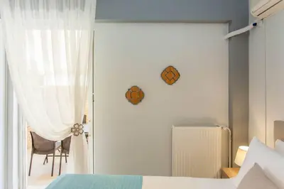 a bedroom with a bed and a sliding glass door at Neoria apartment in Chania Town