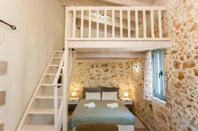 a bedroom with a bunk bed and a ladder at Casa Athelia: Traditional Home, Local Neighborhood in Chania Town