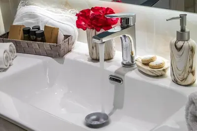 a white sink with a faucet and some towels at Luxury Katsoulakis Apartments in countryside in Alikianós