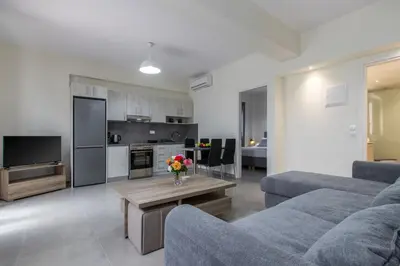 a living room with a couch and a table with flowers at Luxury Katsoulakis Apartments in countryside in Alikianós