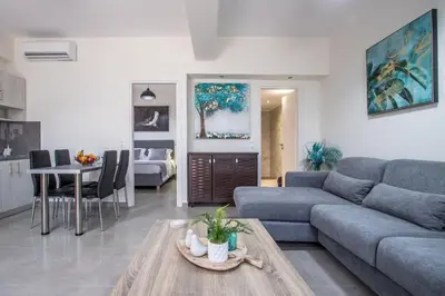 a living room with a couch and a table at Luxury Katsoulakis Apartments in countryside in Alikianós