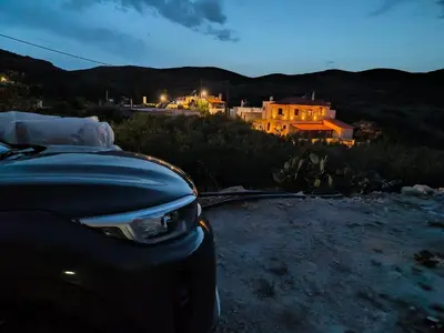 a car parked in front of a house at night at Aloni Studio in Azoyirás