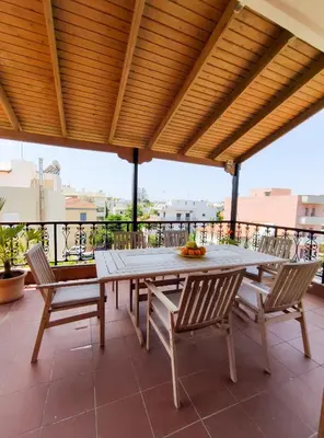 a patio with a table and chairs on a balcony at Rastoni Chania - Guests Apartment in Chania Town