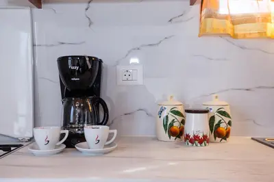 a counter with three cups and a blender on it at Villa Margarita's farm, private pool in Maláthiros