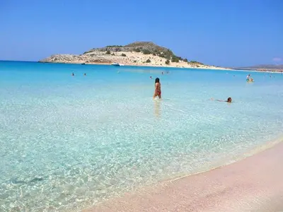 a woman standing in the water at a beach at Villa Margarita's farm, private pool in Maláthiros