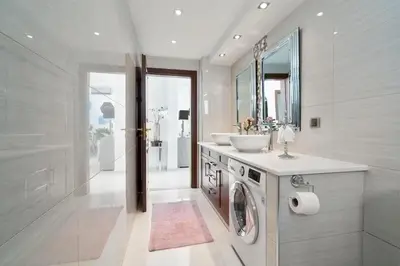 a bathroom with a sink and a washing machine at Chania Boutique Villa - steps from the beach in Chania Town