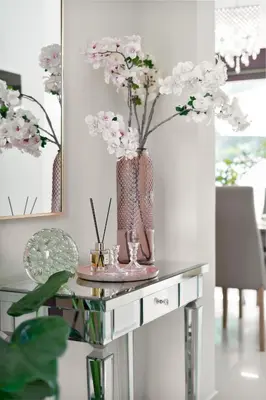 a table with a vase with flowers on it at Chania Boutique Villa - steps from the beach in Chania Town