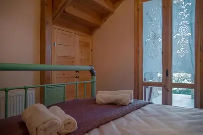 a bedroom with a bed with towels on it at villa archontiko ASKYFOU SFAKIA in Karés