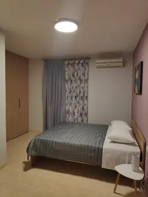 a bedroom with a bed and a table in it at Xenia's countryside guesthouse in Agia Marina Nea Kydonias