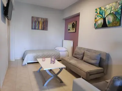 a living room with a couch and a table at Xenia's countryside guesthouse in Agia Marina Nea Kydonias