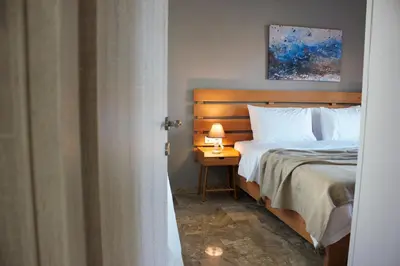 a bedroom with a bed and a table with a lamp at koukounari apartment in Chania city center in Chania Town