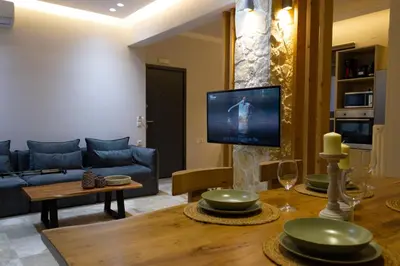 a living room with a couch and a tv at koukounari apartment in Chania city center in Chania Town