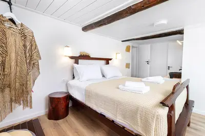 a bedroom with a large bed in a room at Mansion Fabrica in Kalleryianá