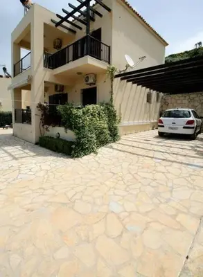 a white car parked in front of a building at Villa Seashell, Private Pool and Magnficent View in Ravdhoúkha