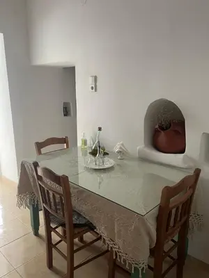a dining room table and chairs with a table and a chair at Casa Elafonisi N1- 10min from the beach in Plokamianá