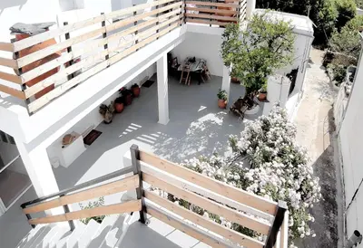 an overhead view of a balcony with a bench and flowers at Casa Elafonisi N1- 10min from the beach in Plokamianá