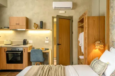 a bedroom with a bed and a small kitchen at Casbah Boutique Hotel in Palaiochóra