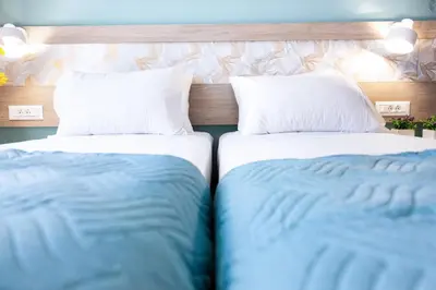 two beds sitting next to each other in a room at Sonio Villas - Que Bella Collection in Plataniás