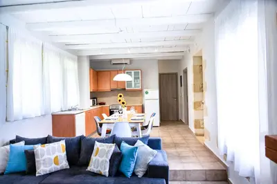 a living room with a couch and a table at Sonio Villas - Que Bella Collection in Plataniás