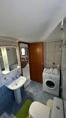 a bathroom with a sink and a washing machine at Eteá Urban Nest living In the Heart of Chania in Chania Town
