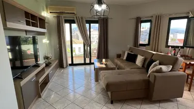 a living room with two couches and a tv at Eteá Urban Nest living In the Heart of Chania in Chania Town