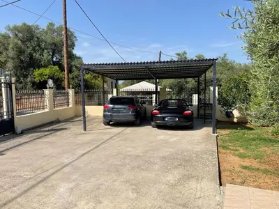 two cars are parked in a parking lot at Chania Casa Portokali in Perivólia