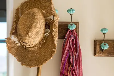 two straw hats hanging on a wall at Villa Remedio in Néon Khoríon
