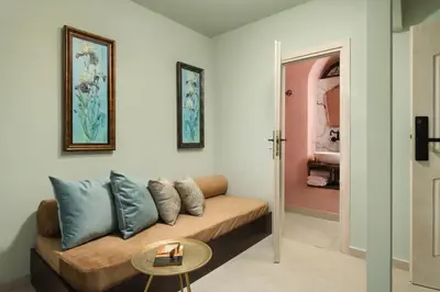 a living room with a couch and a table at Nobili Boutique Hotel in Chania Town